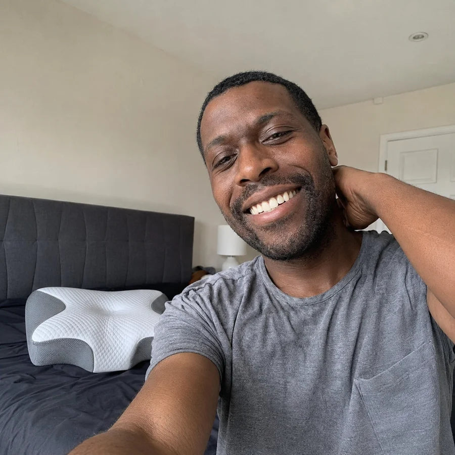 Customer selfie in his bedroom with the Novra Pillow behind him
